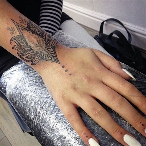 This mandala design across the back of the hand and wrist. Meaningful Tattoos - Wrist dot work tattoo - TattooViral ...