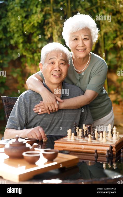 Old Couple In The Yard To Play Chess Stock Photo Alamy