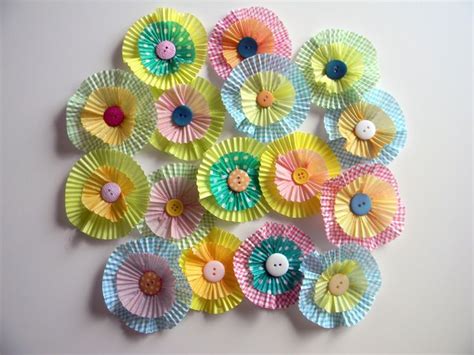 It's kelly from typically simple where i share kids' crafts, printables, and learning activities that the whole family will enjoy doing together! "Flowers" out of cupcake liners and buttons. So cute ...