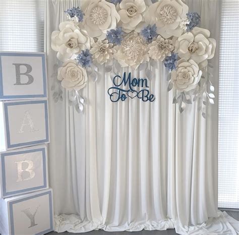 This baby shower flower arrangement is full of beautiful burnt orange, red and yellow flowers and is perfect for a summer or fall baby shower. Boy themed baby shower decor, paper flower backdrop | Baby ...