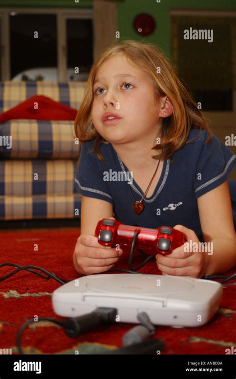 Young Girl Engrossed With Playing Her Playstation Computer Game Stock