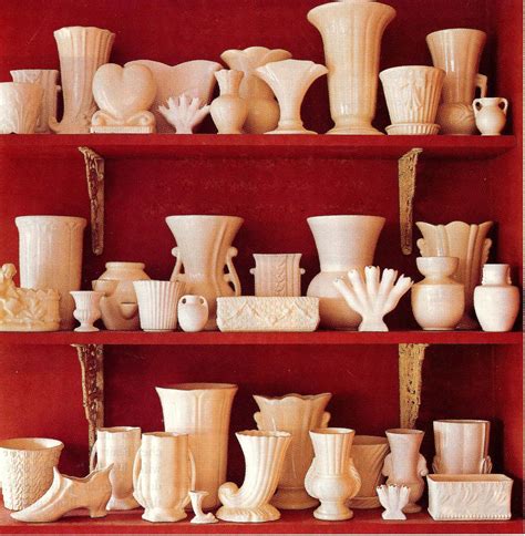 Displaying Ceramics White Pottery Displayed Against A Dark Red Wall