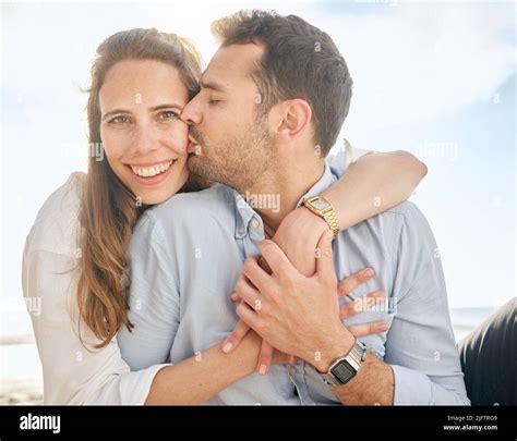 Beautiful Middle Aged Woman Being Kissed On The Cheek By Her Husband