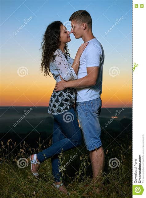 Romantic Couple Embrace At Sunset Beautiful Landscape And Bright Yellow Sky Love Tenderness