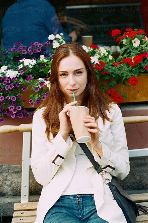 Young Woman Drinking Milkshake Outdoors By Stocksy Contributor Amor