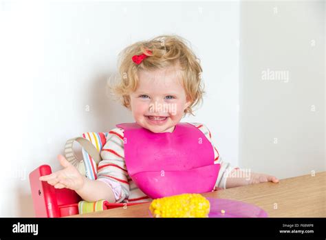 One Year Old Baby Smiling At The Dinner Table England Uk Stock Photo