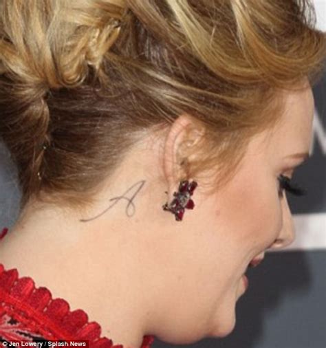 Let's survey her handful of tattoos. Adele shows off 'paradise' tattoo on her hand... an almost ...