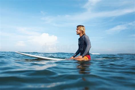 Surfing Handsome Surfer Holding White Surfboard Above Head Smiling