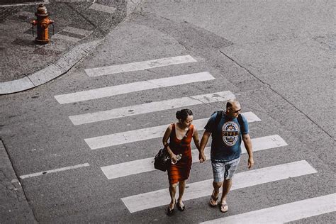 Human Man And Woman Walking On Pedestrian Lane During Daytime People