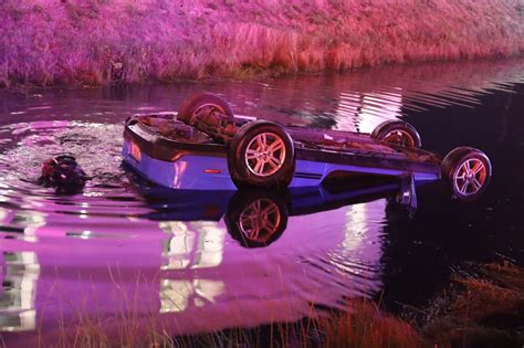 Man pulled from car after flipping over into retention pond