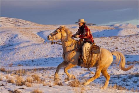 Cowgirl Riding In The Last Light Winters Snow And The Bighorn Mountains