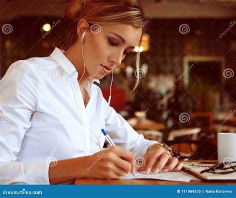 Smart Woman Writing Down Her Ideas And Drinking Coffe In Cafe Stock