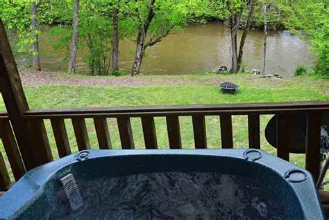 Bubbly hot tub and rocking chairs. Pigeon Forge Cabin - Rushing River Lodge - 5 Bedroom ...