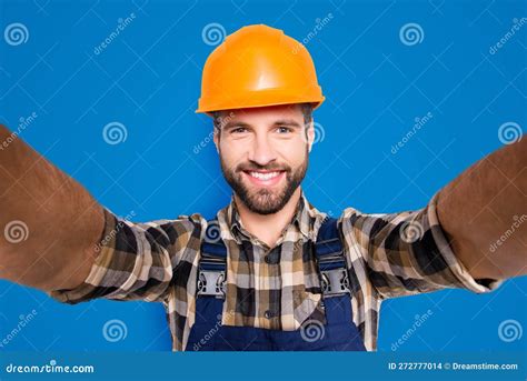 Portrait Of Handsome Cheerful Repairer In Safety Helmet With Stubble