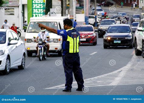 Traffic Officers Direct And Manage The Flow Of Traffic At A Busy Rotonda Or Roundabout Road