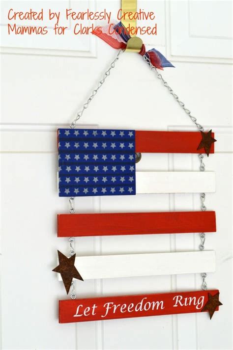An American Flag Made Out Of Wood Hanging From A Chain With The Words