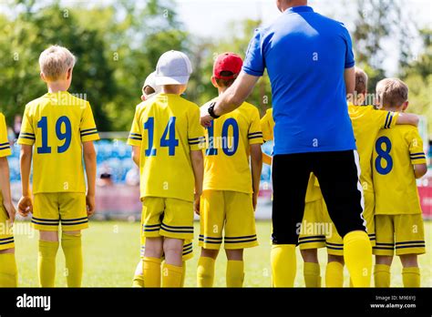 Youth Football Coach Talking To Childrens Soccer Team Young Football