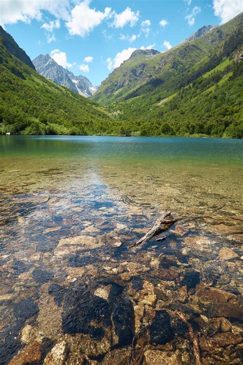Mountain Lake With Clear Water In Distance Mountains And Slopes Green