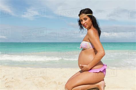 A Pregnant Woman Poses On The Beach At The Water S Edge Honolulu