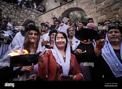 dohuk iraq 19th apr 2022 iraqi yazidi women hold lit candles and torches at the lalish