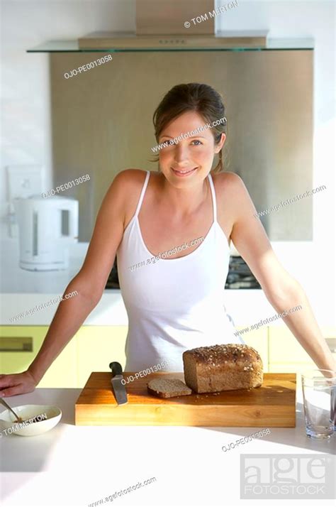Woman In Kitchen With Bread Smiling Stock Photo Picture And Royalty