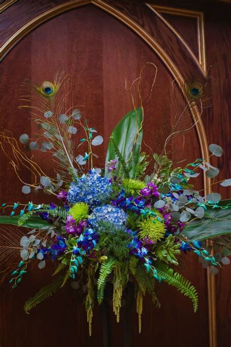 White with feather accents and a touch of bling. Large Altar arrangements for peacock themed wedding using ...