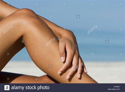 Woman Touching Bare Legs At The Beach Cropped Stock Photo Alamy