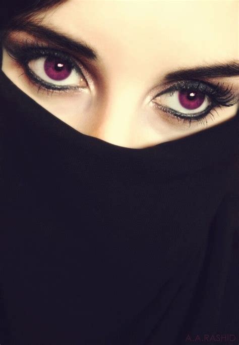 An Image Of A Woman With Purple Eyes And Black Veil On Her Head Looking At The Camera