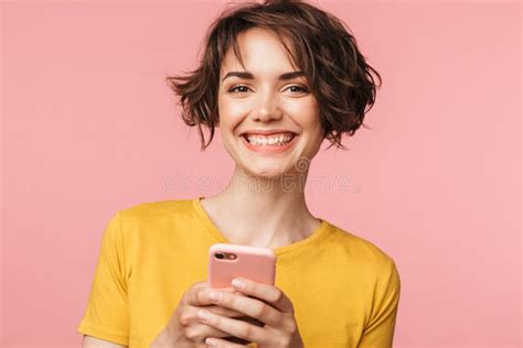 Happy Young Beautiful Woman Posing Isolated Over Pink Wall Background Using Mobile Phone Stock