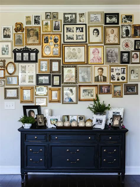 A Wall Full Of Framed Pictures And Photos On Its Sideboard In A Living