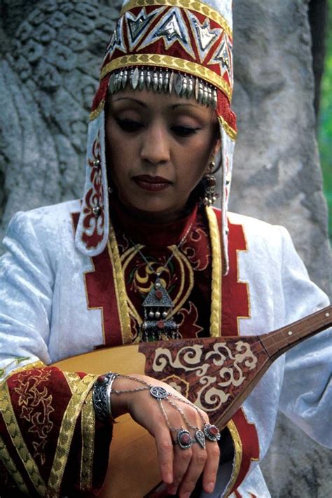 Kazakh Woman In Traditional Dress With Traditional Instrument