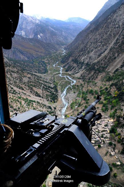 An Aerial Gunner Surveys The Surrounding Area During A Combat Mission