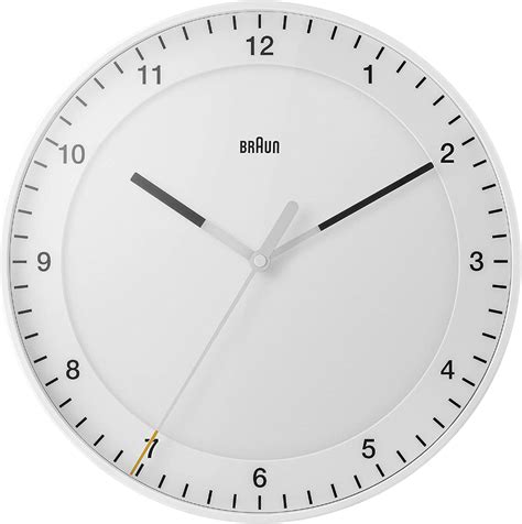 A White Wall Clock With Black Hands And Numbers