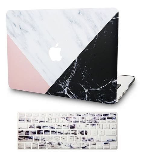 An Apple Keyboard And Marble Macbook Pro With The Cover Partially Open
