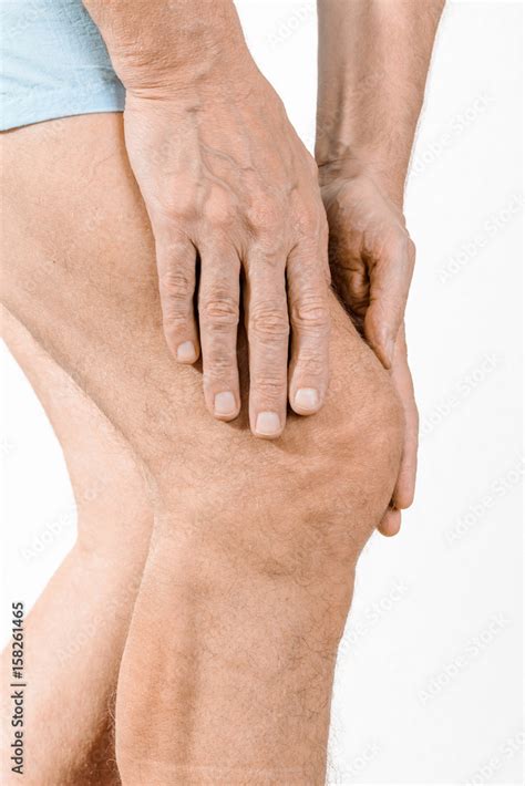 Athlete Man Massaging A Painful Quadriceps And The Knee After A Sport