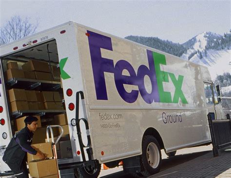 Fedex Ground Vehicle And Employee Loading Parcels For Delivery Save