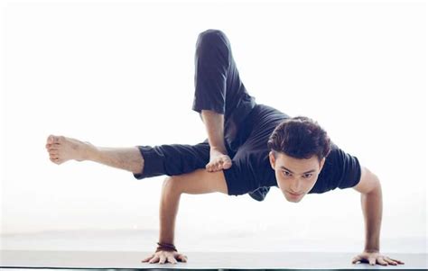 A Man Is Doing Yoga On A Mat