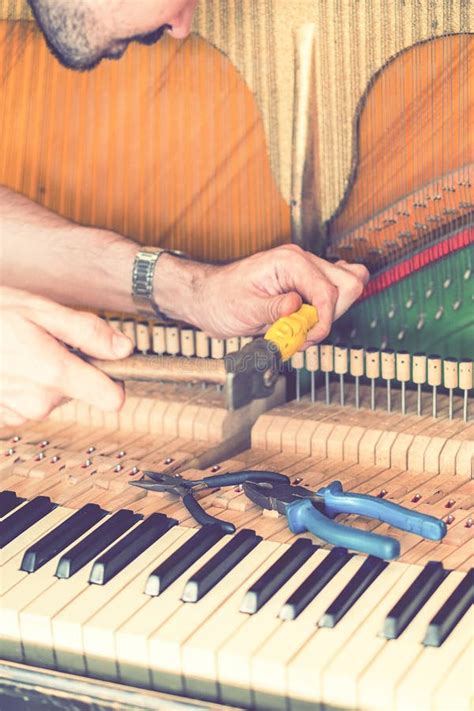 Piano Tuning Process Closeup Of Hand And Tools Of Tuner Working On
