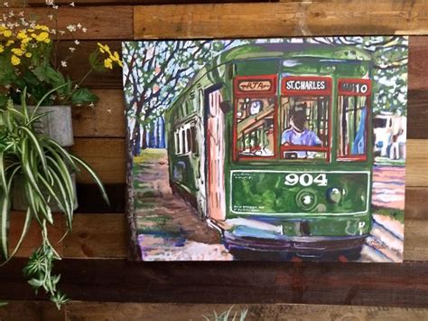 A Painting Of A Green Trolley Car On A Wooden Wall Next To Potted Plants
