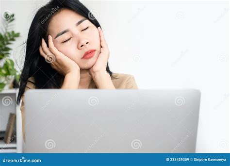 Sleepy Asian Businesswoman Fall Asleep At Office Desk While Working On