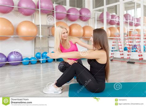 Young Woman Exercising With Her Fitness Instructor Stock Image Image