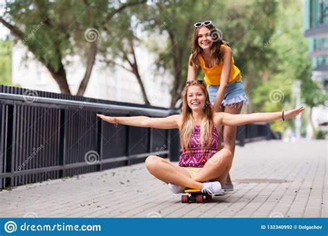 Teenage Girls Riding Skateboard On City Street Stock Photo Image Of