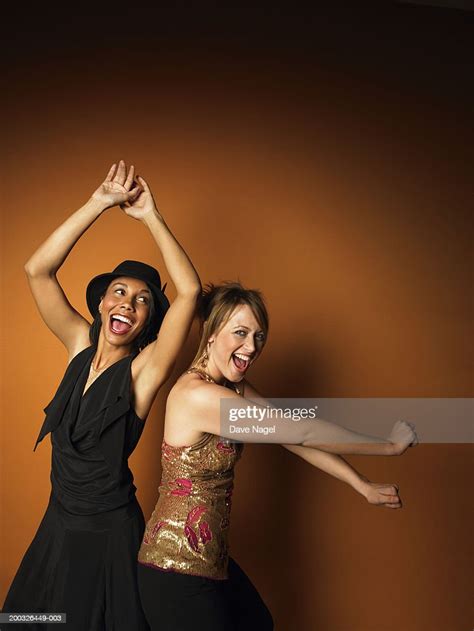 Two Young Women Dancing Smiling Portrait High Res Stock Photo Getty