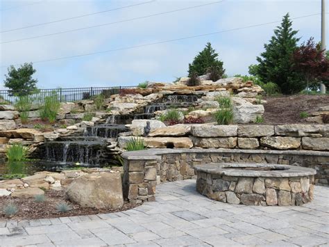 Natural Stone Water Feature With Koi Pond And Landscaping