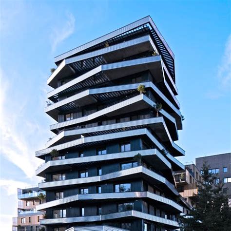 A Tall Building With Balconies On The Top