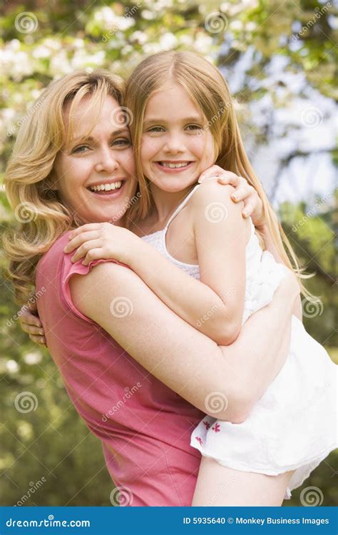 Mother Holding Daughter Outdoors Smiling Stock Photo Image 5935640