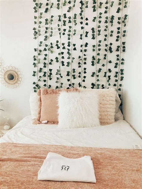A Bed With Pillows And Blankets On It In Front Of A Headboard Made Out