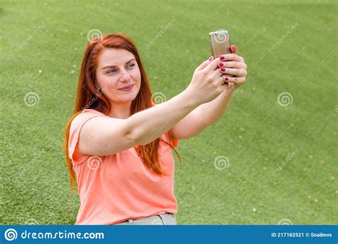 Outdoor Portrait Of Beautiful Ginger Girl Taking A Selfie Happy Young
