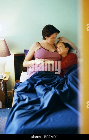 Mother With Sons On Bed In Hotel Room In The Morning Stock Photo Alamy