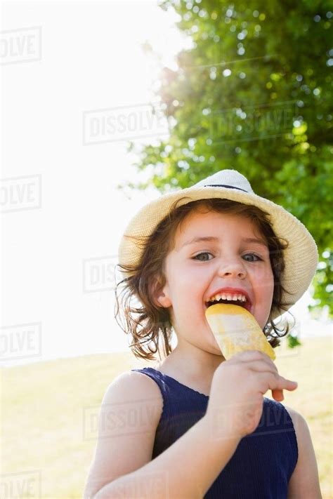 Girl Eating Popsicle Outdoors Stock Photo Dissolve